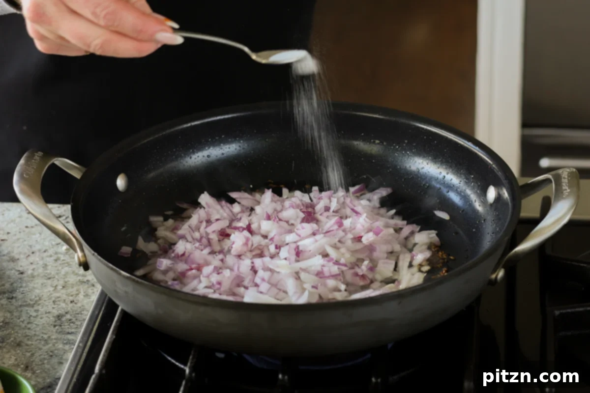 adding salt to the onion