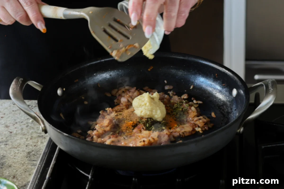 adding ginger garlic paste to the pan