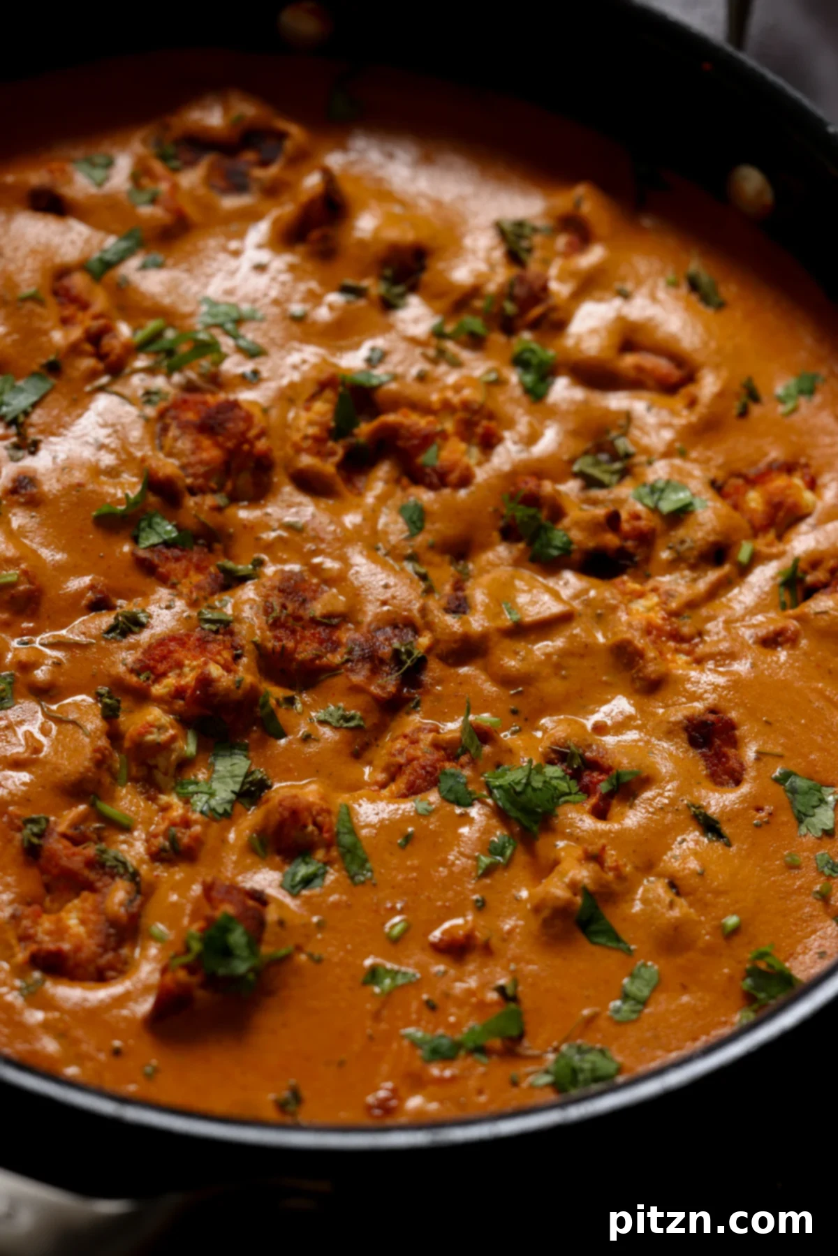 close-up of restaurant-style butter chicken in the pan