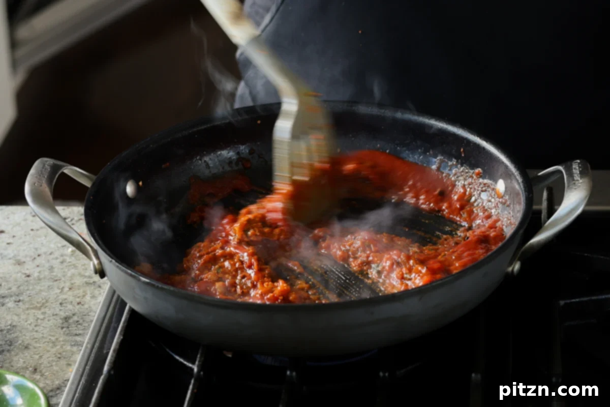 mixing in the tomato puree