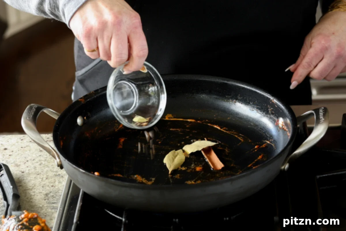 adding more whole spices to the pan
