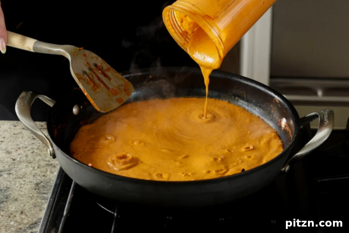 adding the blended sauce back to the pan