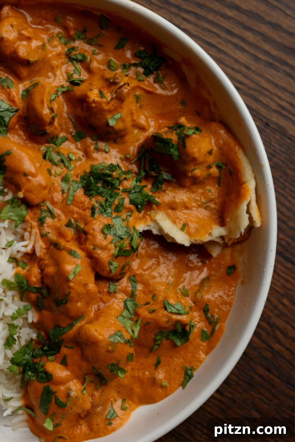 plate of vegan butter chicken with naan