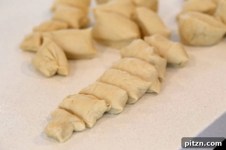 Cutting the risen Vegan Pretzel dough into strips and then into bites.