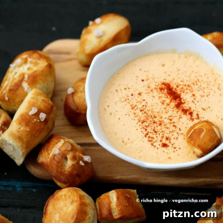 Freshly baked Vegan Pretzel Bites served with a bowl of Spicy Mustard Dip.