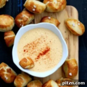 Vegan Pretzel Bites on wooden board with spicy mustard dip in white bowl