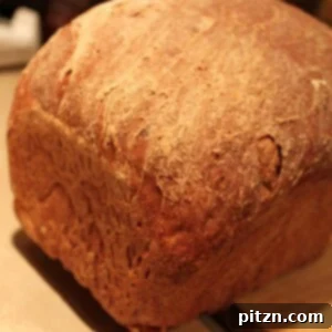 Rustic Apple Blueberry Wheat Loaf 2 A loaf of Blueberry Apple Wheat Bread on a wooden chopping board