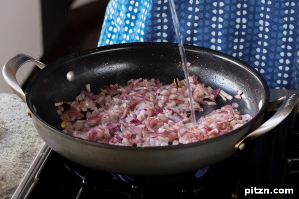 South Indian Soulmate Lentils 13 Adding a splash of water to onions as they cook for even browning.