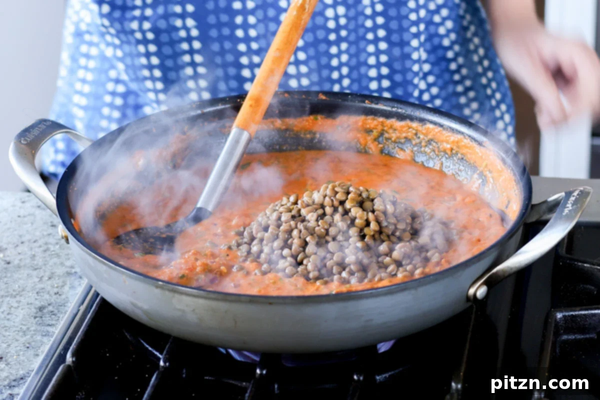 South Indian Soulmate Lentils 18 Adding cooked lentils to the flavorful Marry Me sauce in the pan.
