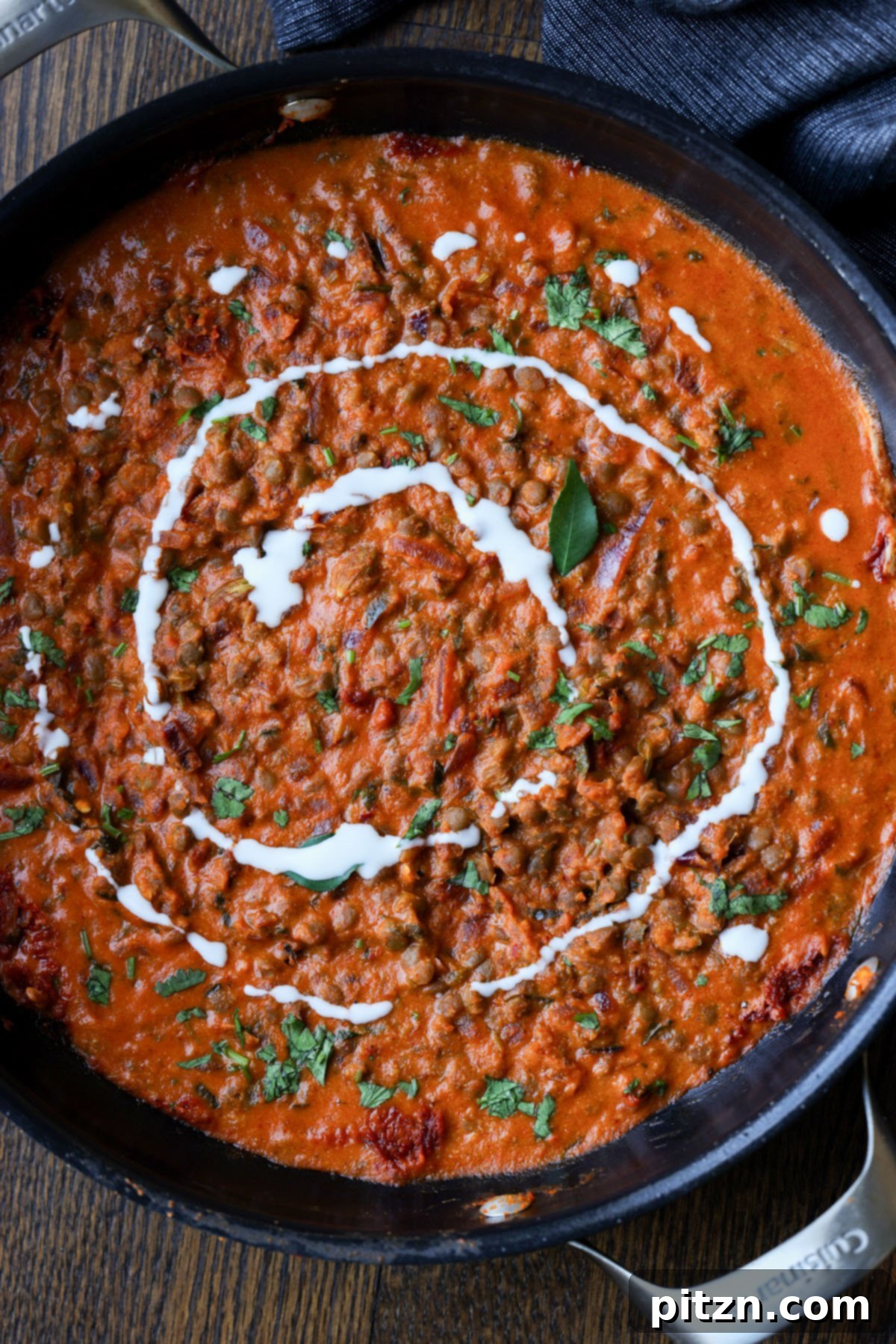 South Indian Soulmate Lentils 4 Close-up of South Indian Marry Me Lentils in a pan with a swirl of non-dairy yogurt.