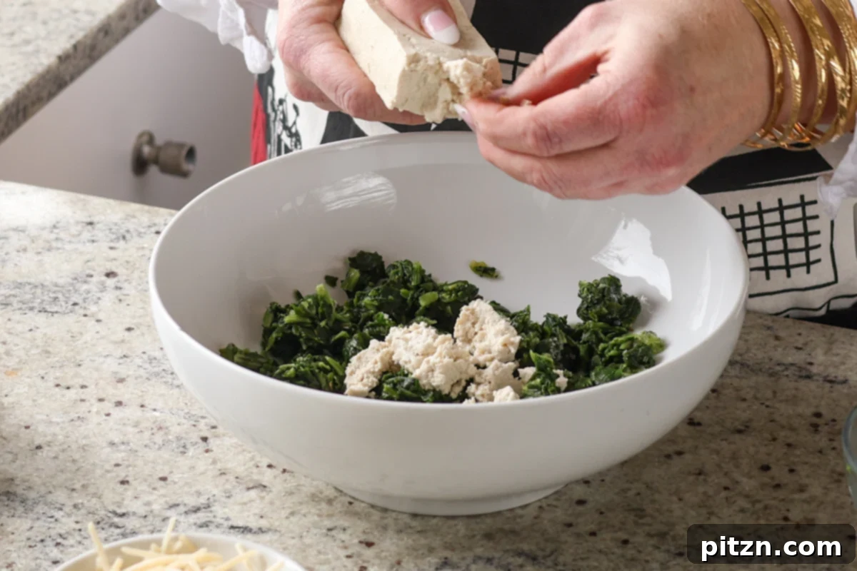 Marry Me Tofu Lasagna Bake 11 crumbling tofu into the bowl of spinach