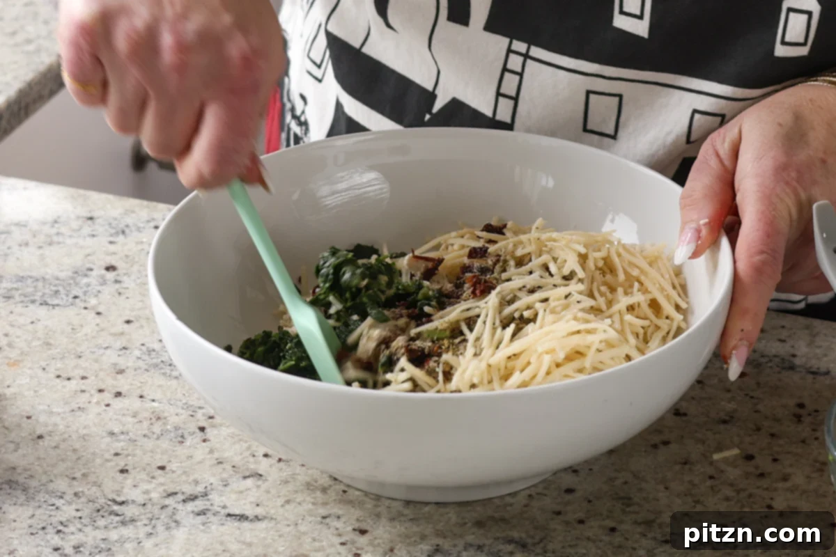 Marry Me Tofu Lasagna Bake 13 adding cheese to the bowl