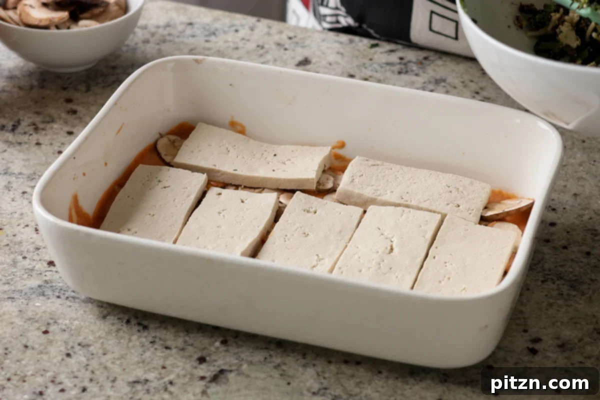 Marry Me Tofu Lasagna Bake 17 adding tofu to the baking dish