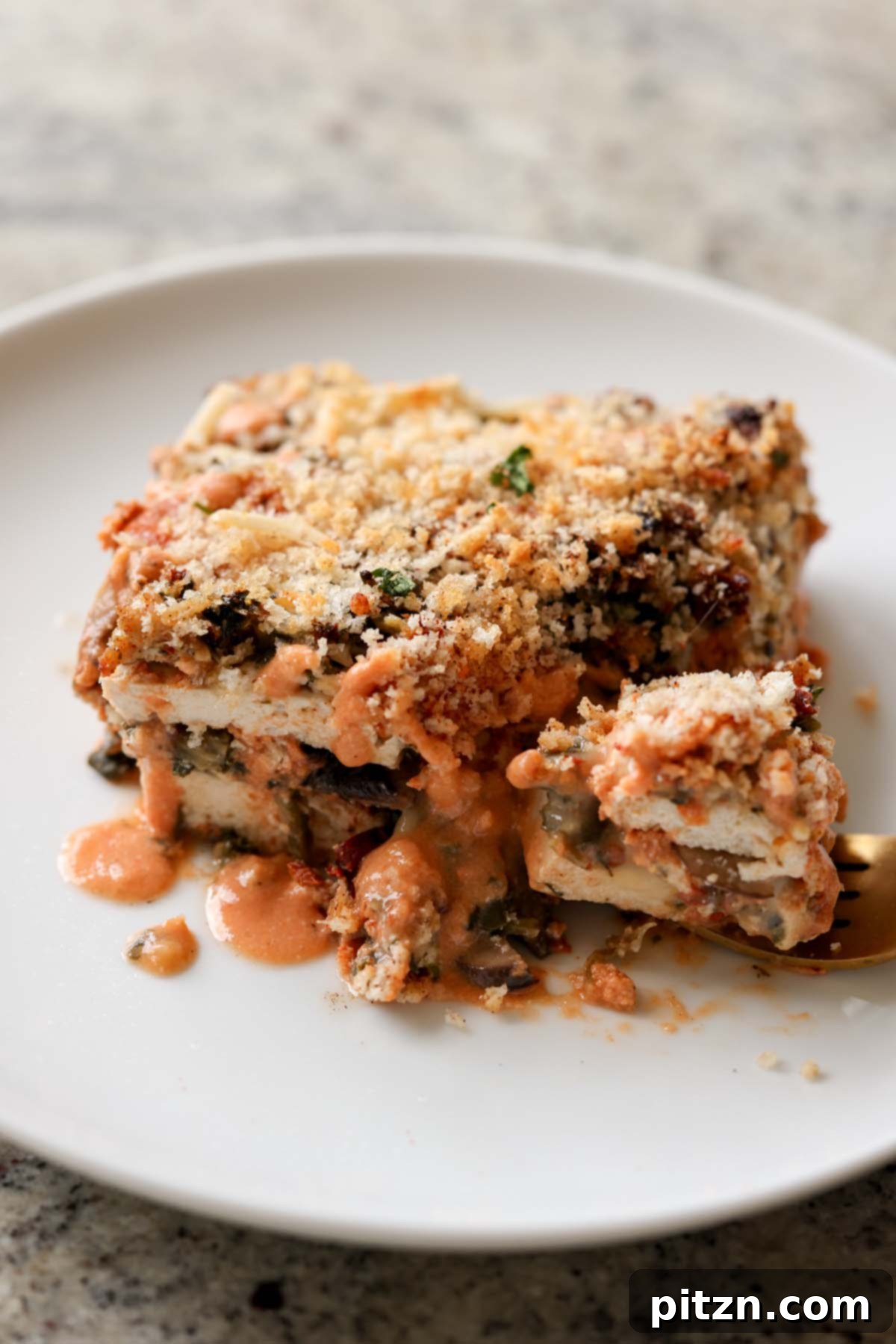 Marry Me Tofu Lasagna Bake 5 fork taking a bite of marry me tofu