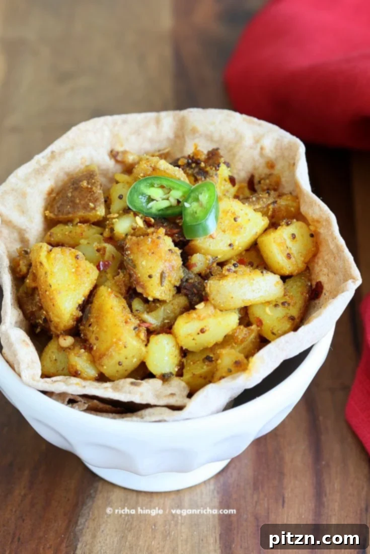 Golden Fiery Potato Crunch 4 Close-up of crispy, golden-brown spiced potatoes garnished with fresh cilantro.