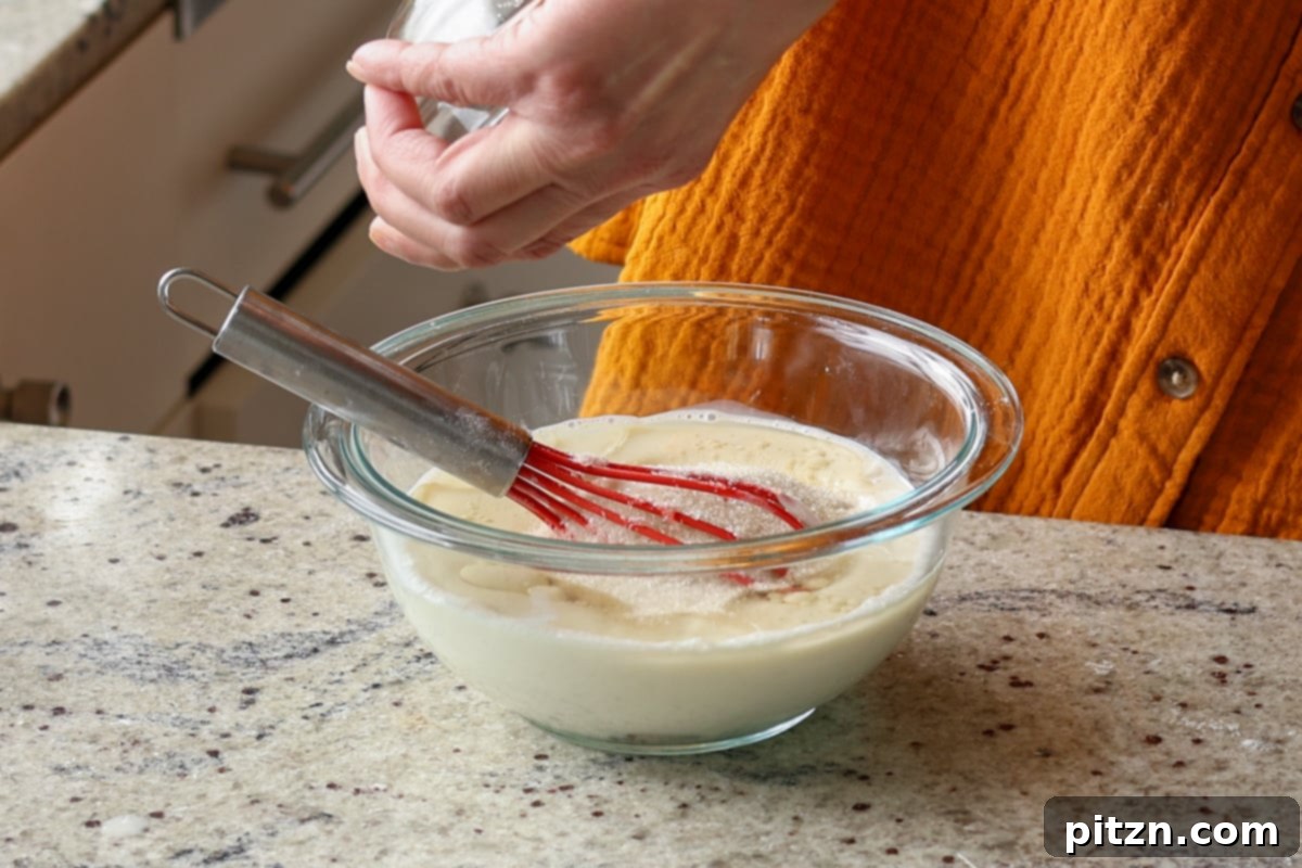 Pistachio Perfection Trio 14 Pouring non-dairy milk, sugar, and vinegar into a bowl to create a vegan buttermilk mixture for the cake.