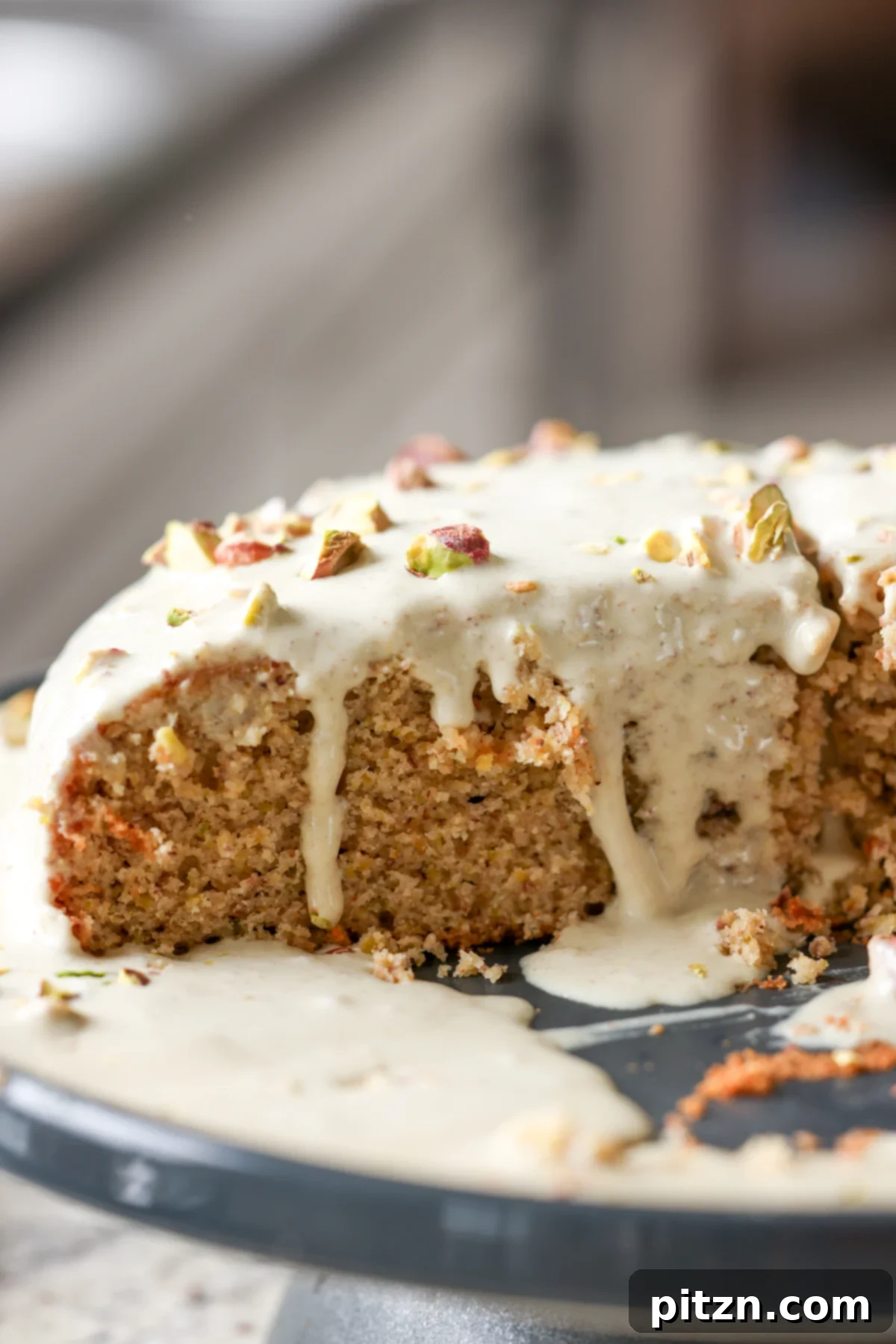 Pistachio Perfection Trio 5 Close-up of the triple pistachio cake, highlighting the smooth pistachio cream topping and the scattering of chopped pistachios.