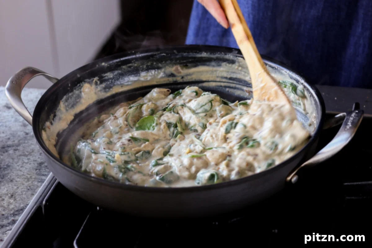 Wilted spinach mixed into the creamy sauce with gnocchi and artichokes.