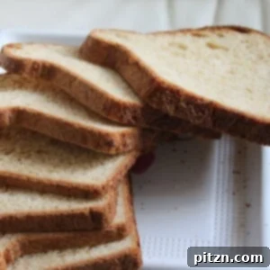 Golden Harvest Pear & Carrot Oat Bread 2 A pear carrot and oats bread loaf sliced on top of a white plate