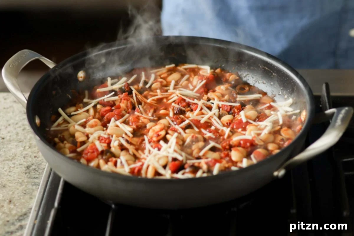 Zesty Mediterranean Butter Beans 15 adding vegan mozzarella to the pan