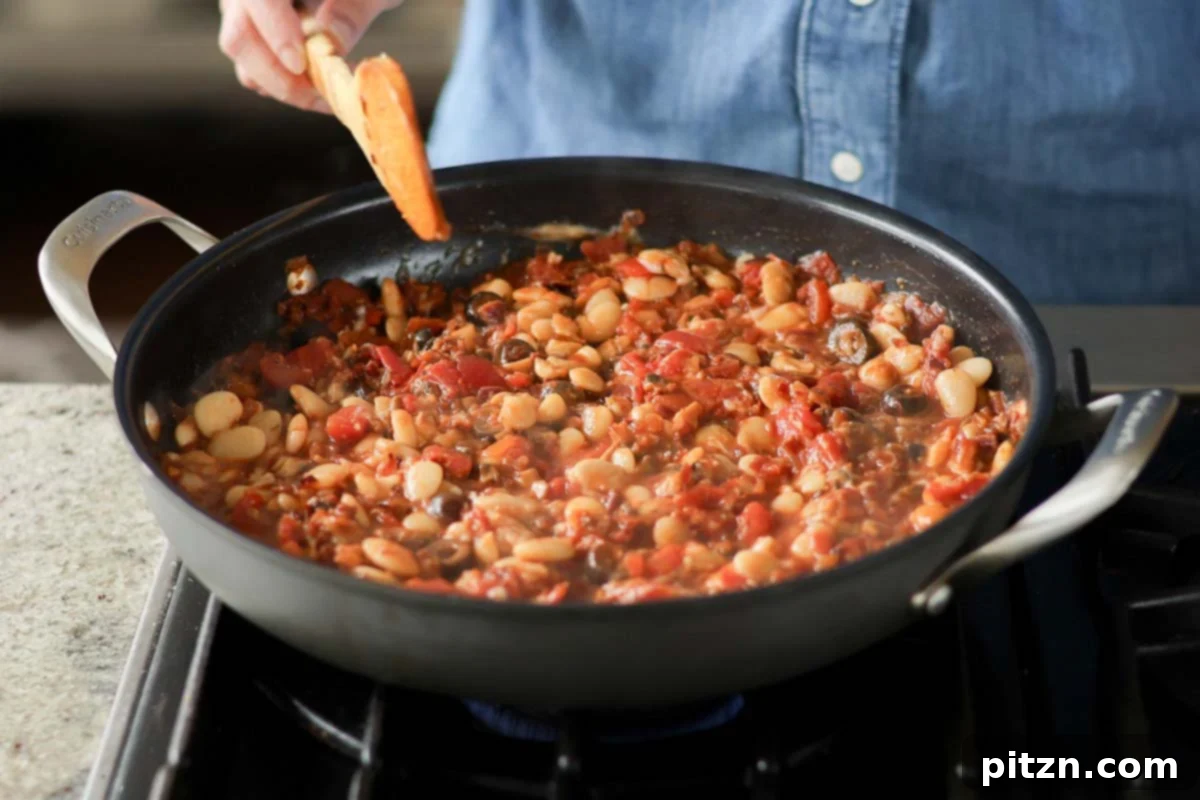 Zesty Mediterranean Butter Beans 16 puttanesca beans in the pan before simmering
