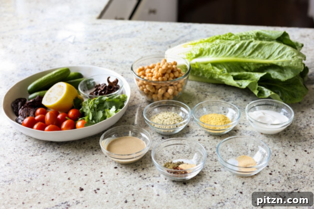 Sun-Drenched Spinach Salad with Zesty Olive-Chickpea Crunch 7 A vibrant display of fresh ingredients for the summer spinach salad on a kitchen counter, ready for preparation.