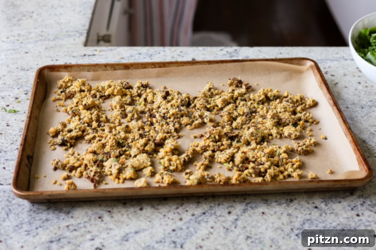 Sun-Drenched Spinach Salad with Zesty Olive-Chickpea Crunch 8 Chickpea crumble mixture spread on a baking sheet before being baked to perfection.