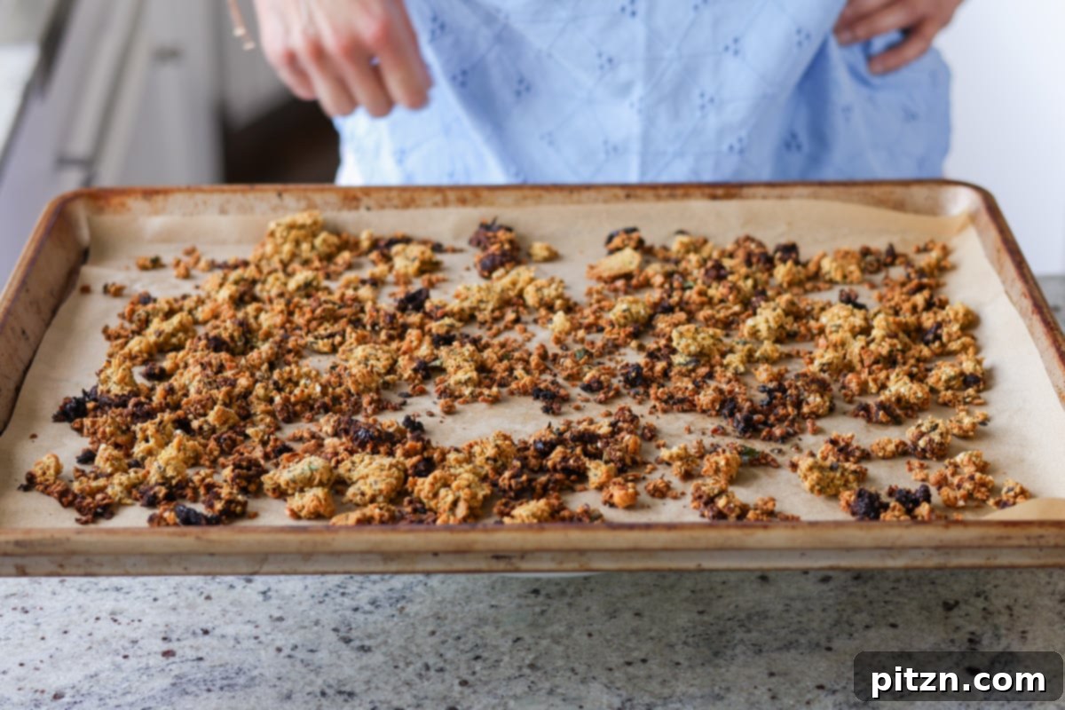 Sun-Drenched Spinach Salad with Zesty Olive-Chickpea Crunch 9 Crispy chickpea crumble evenly baked and golden on a baking sheet, ready for the salad.