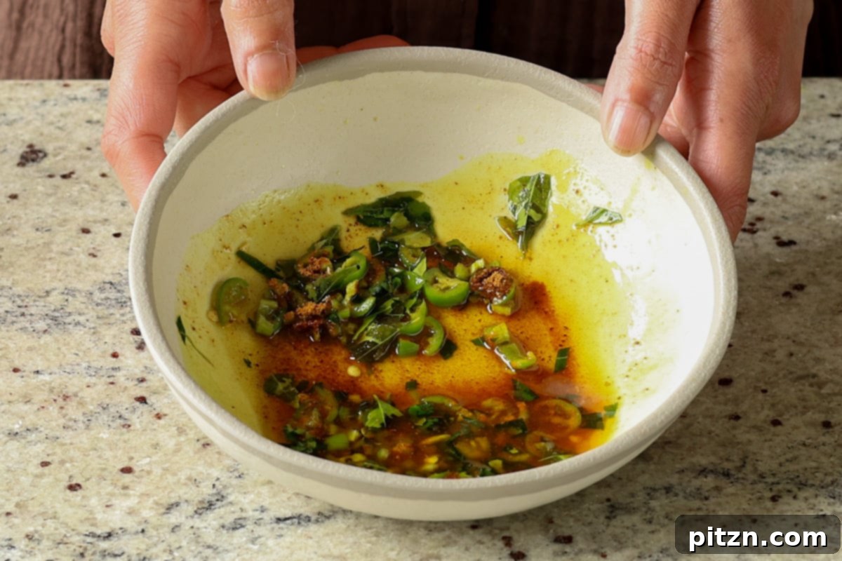Lentil Protein World Tour Mix 15 Aromatic tadka (tempering) after adding hot oil and ground spices to chili and curry leaves.
