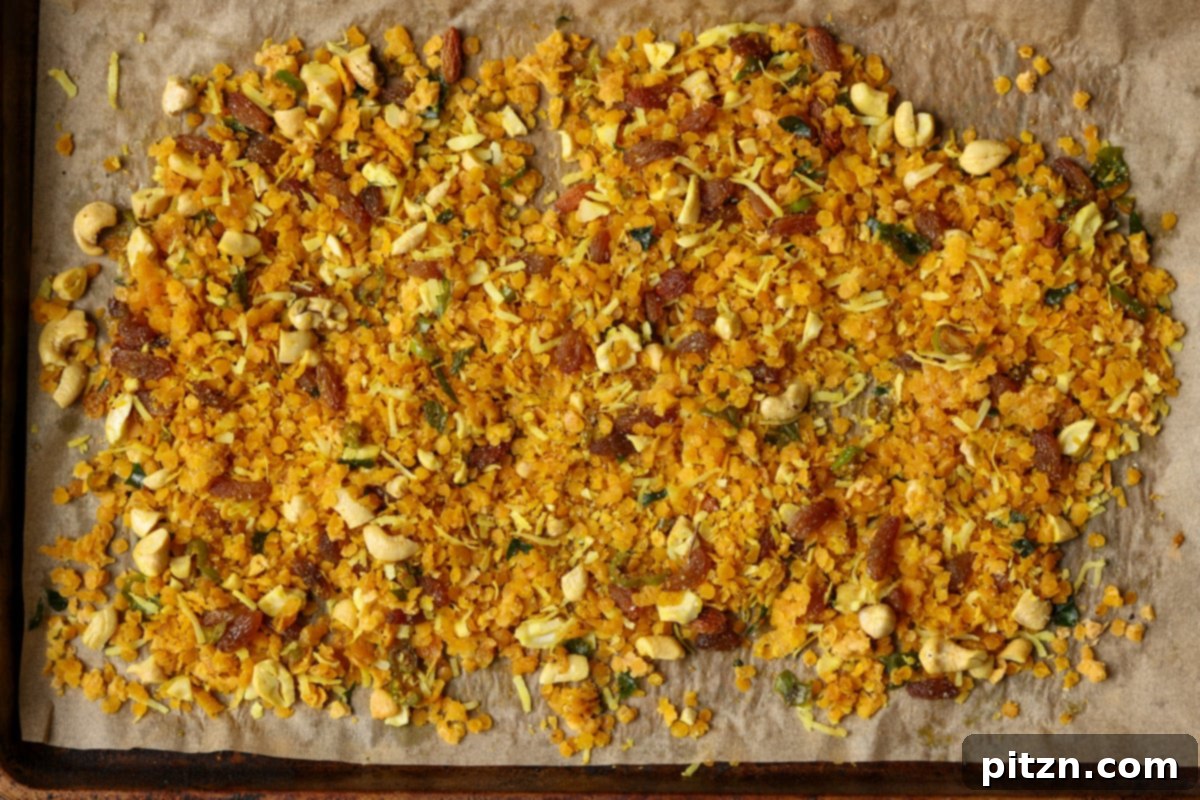 Lentil Protein World Tour Mix 22 Indian-spiced savory lentil granola, baked to perfection on a baking pan.