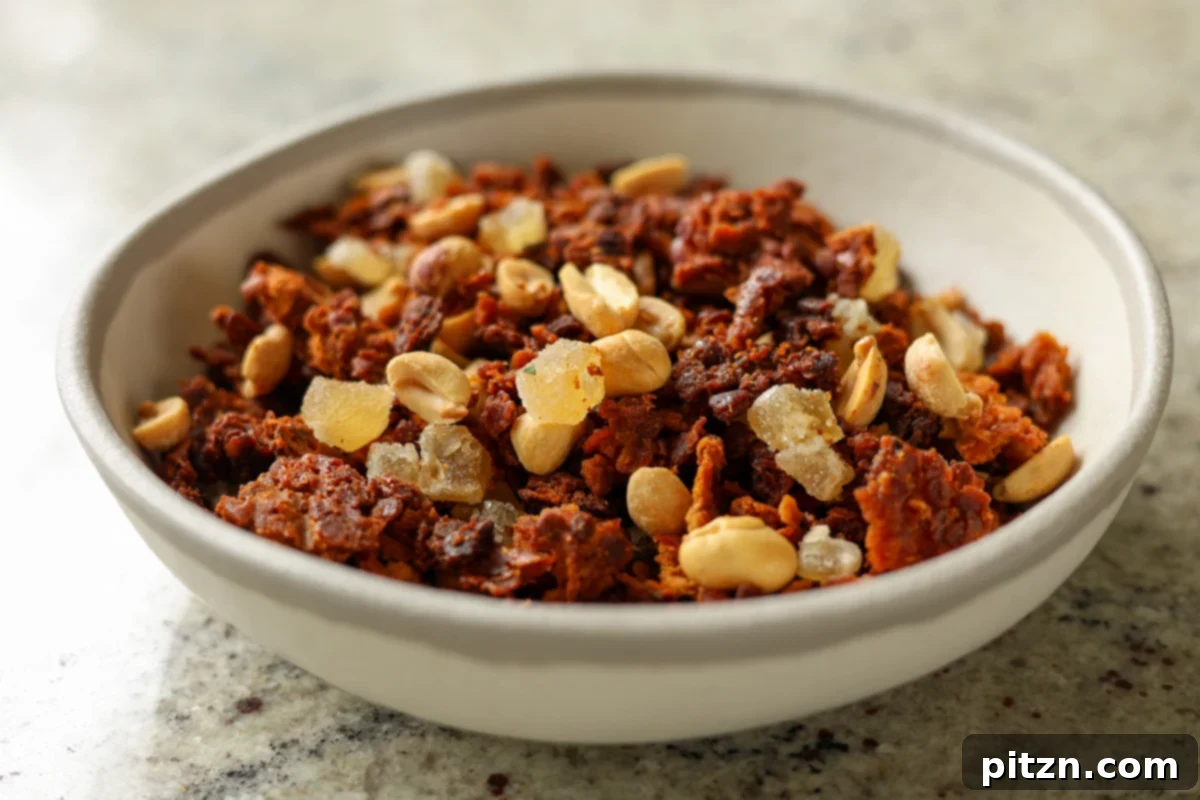 Lentil Protein World Tour Mix 28 Finished peanut gochujang granola, ready to be enjoyed, served in a bowl.