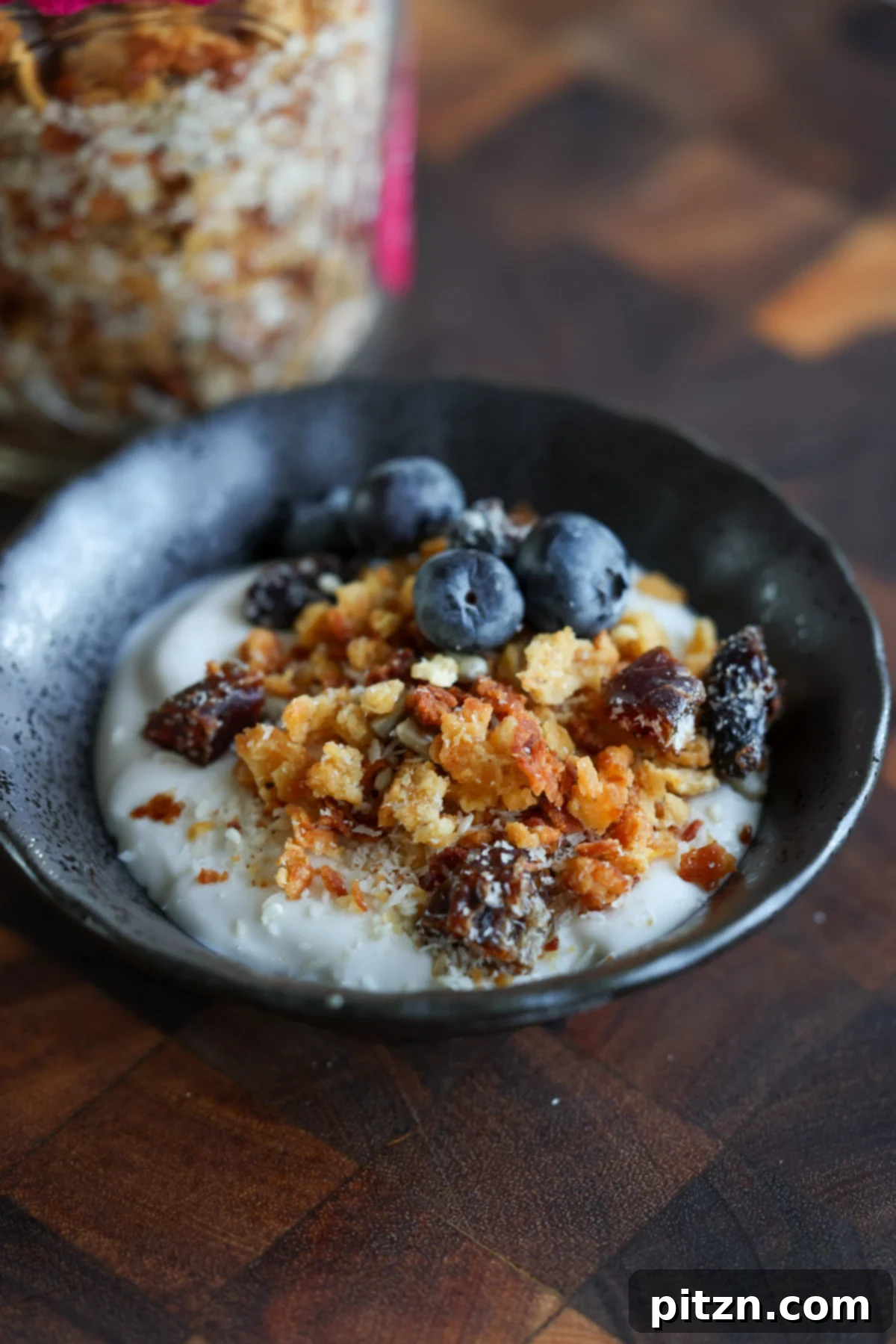 Close-up of crunchy red lentil granola with coconut and cranberries in a bowl