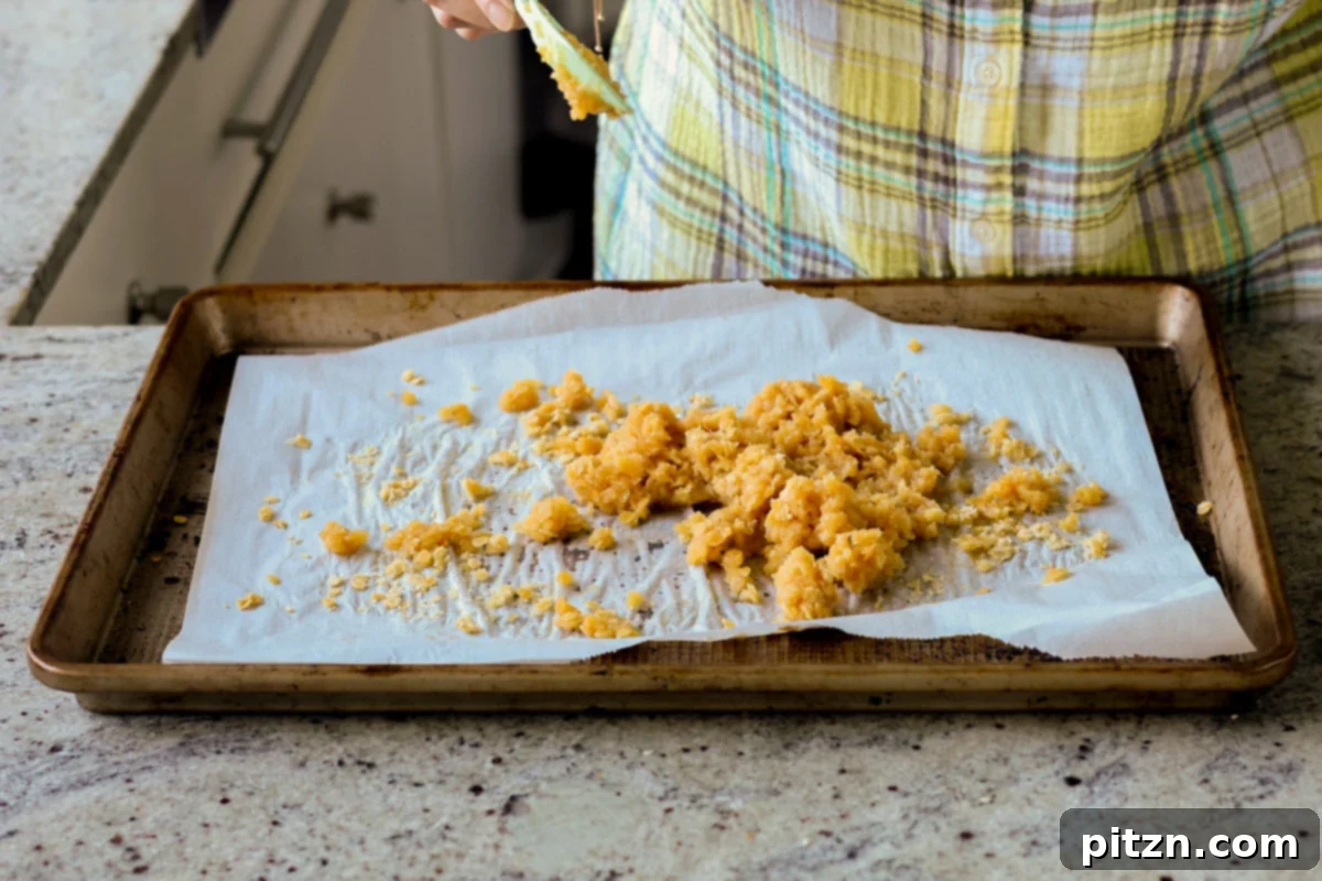Red lentils thoroughly mixed with the sweet maple syrup coating on a baking sheet