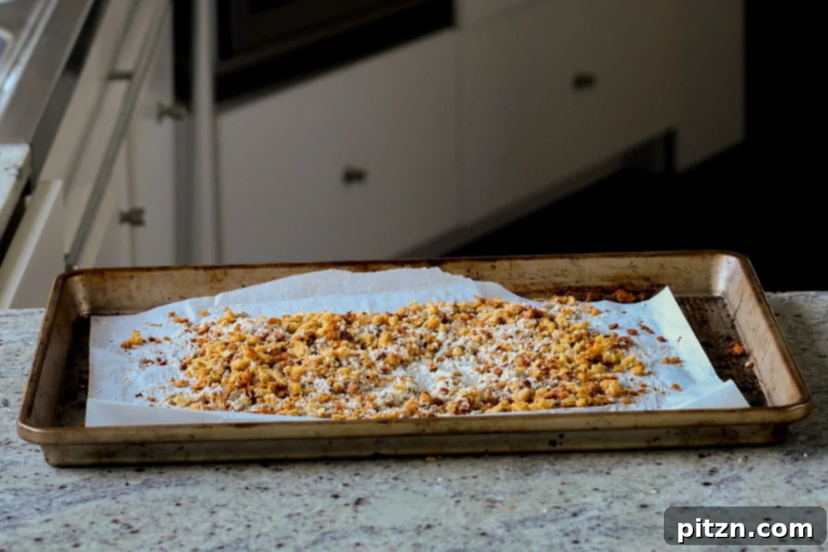 Perfectly baked red lentil granola with coconut and seeds, glistening on the baking sheet