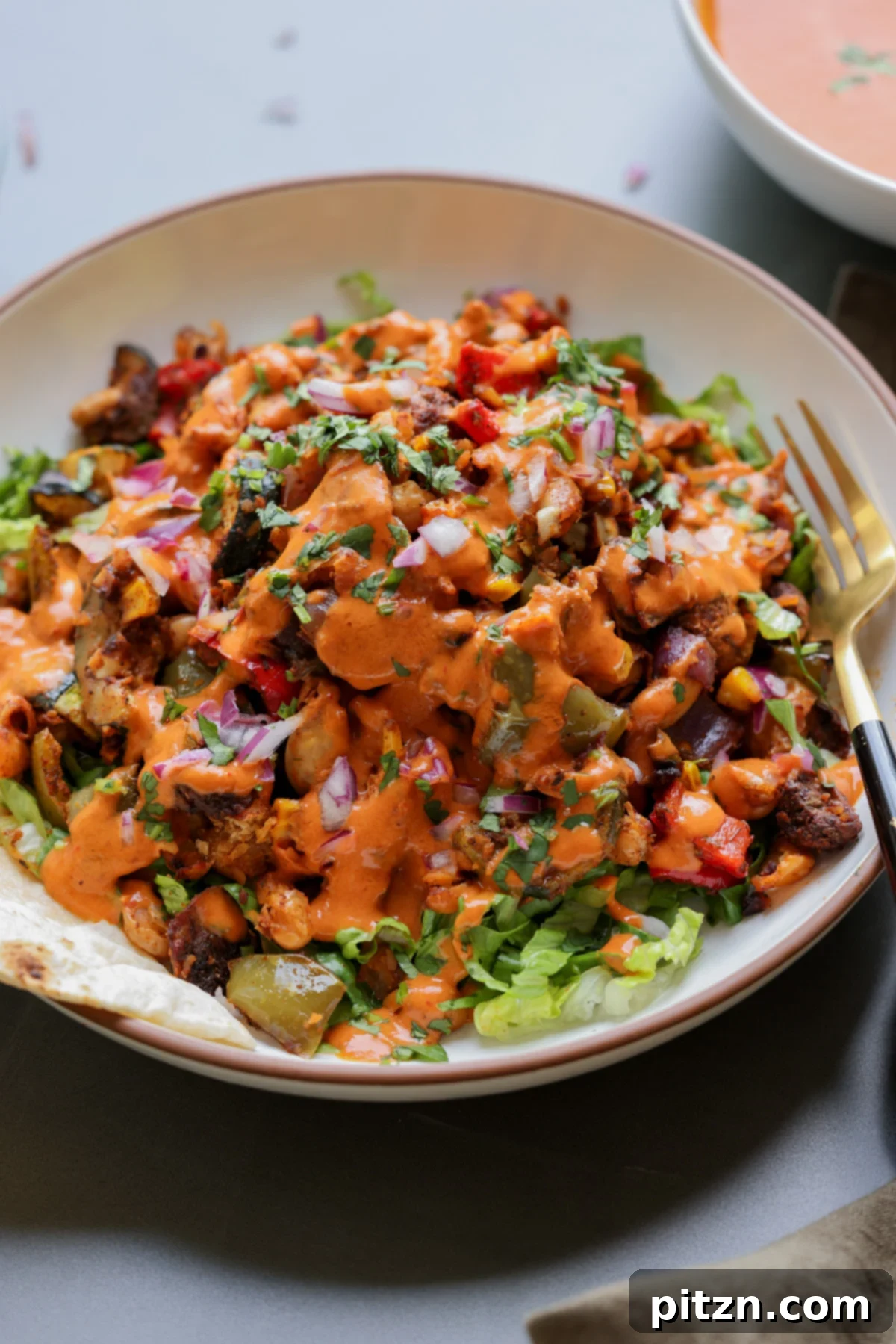 One-Pan Smoky Cajun Veggies and Smashed White Beans 2 cajun sheet pan beans veggies in a bowl