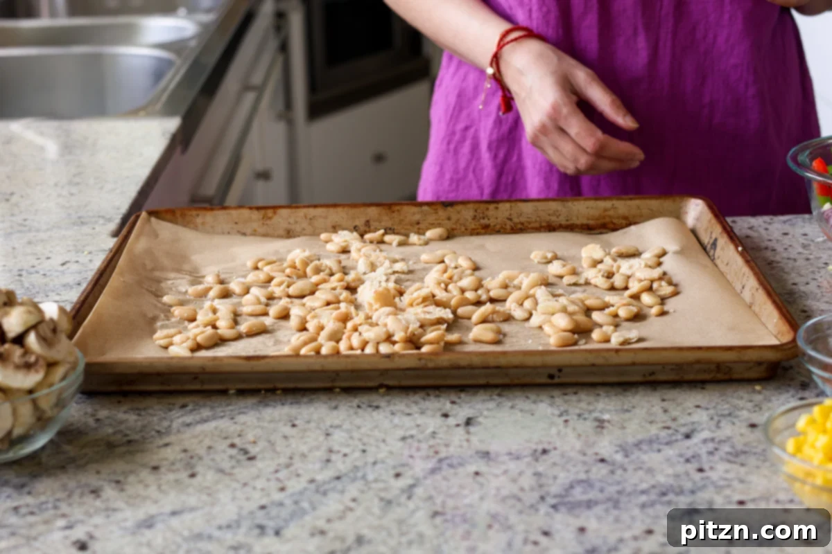 One-Pan Smoky Cajun Veggies and Smashed White Beans 9 smashing beans on the sheet pan