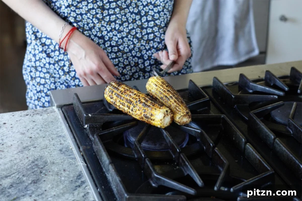 Tropical Chickpea & Mango Salad with Spiced Lime-Pepper Drizzle 8 Charred roasted corn on the cob cooling on a cutting board, ready for the kernels to be removed.