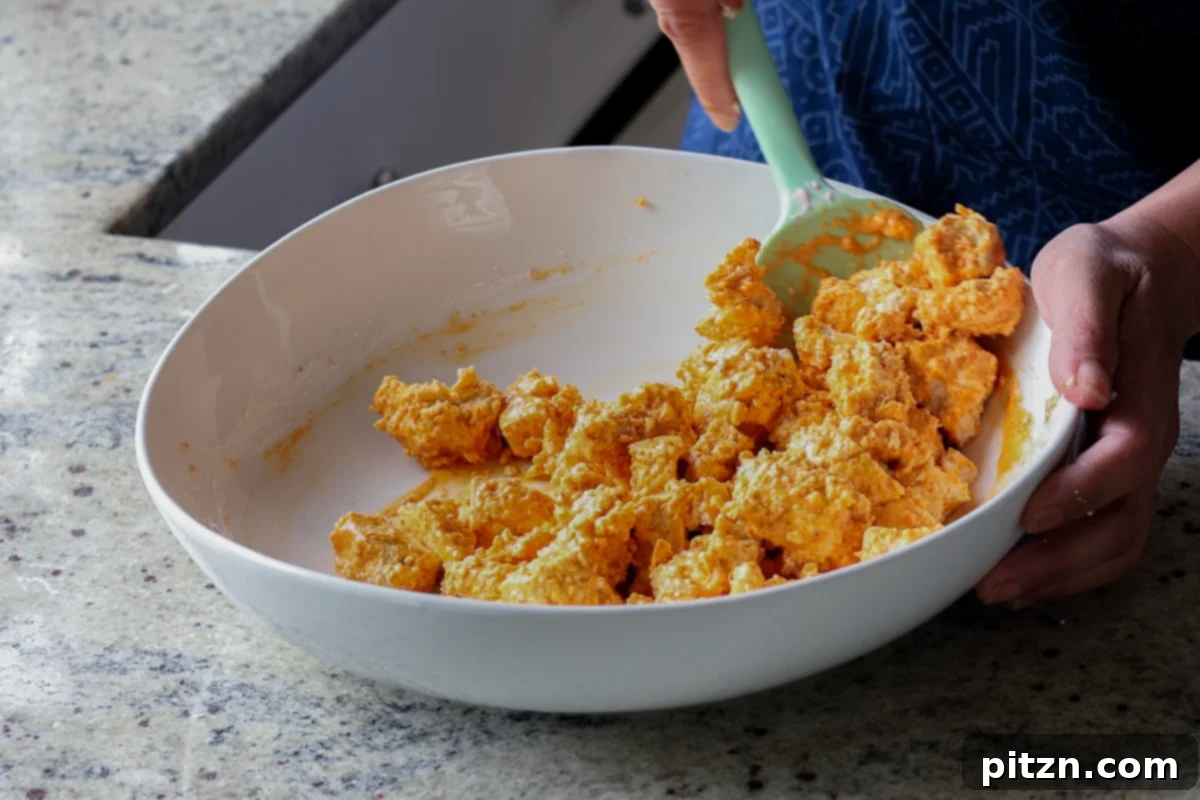 Crispy Vegan 555 Chicken Bites 14 Tofu pieces thoroughly coated in the Vegan Chicken 555 batter, ready for cooking.