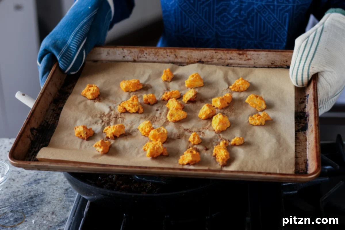 Crispy Vegan 555 Chicken Bites 16 Crispy Vegan Chicken 555 pieces on a baking sheet after baking.