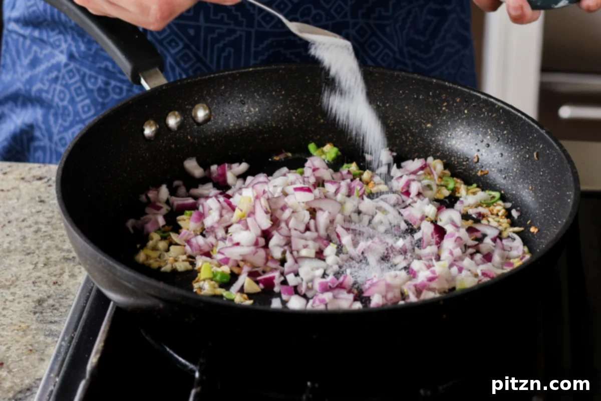 Crispy Vegan 555 Chicken Bites 22 Adding chopped red onion to the pan with the cooked aromatics.
