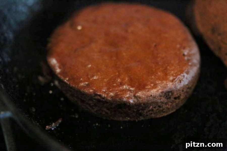 Removing cookie cutter from a cooked chocolate cake layer