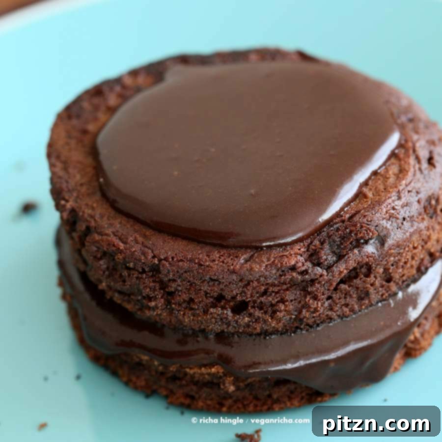 Assembling a vegan chocolate layer cake with ganache