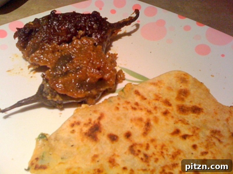 Mom's Aloo Paratha and Sanjeev Kapoor's Baghare Baingan A Flavorful Pairing 2 Aloo Paratha, a delicious Indian flatbread stuffed with spicy potatoes, served hot with a side of yogurt and pickle.