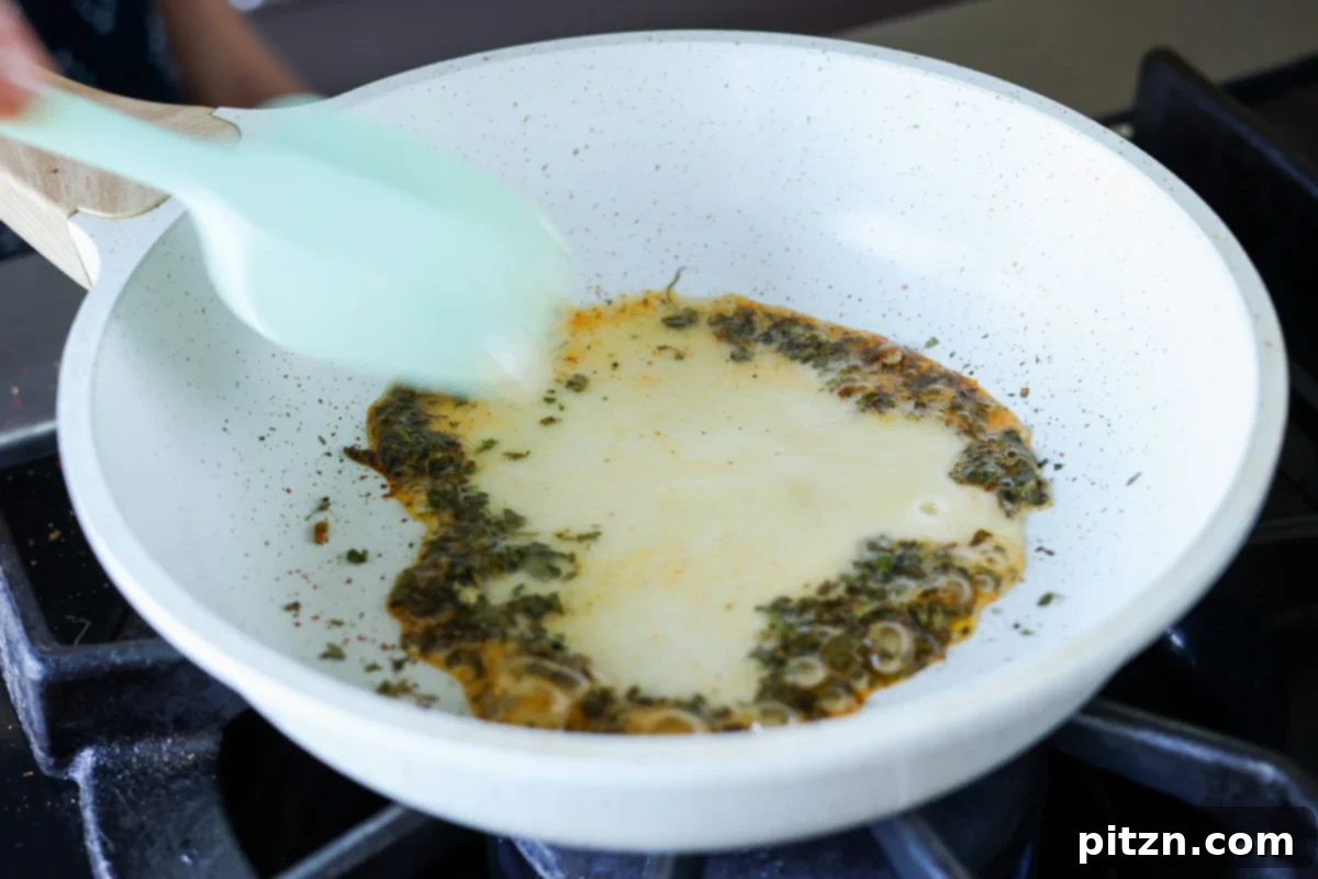Restaurant-Quality Dal Makhani at Home 16 Dried fenugreek leaves (kasuri methi) being dry toasted in a small skillet until fragrant.