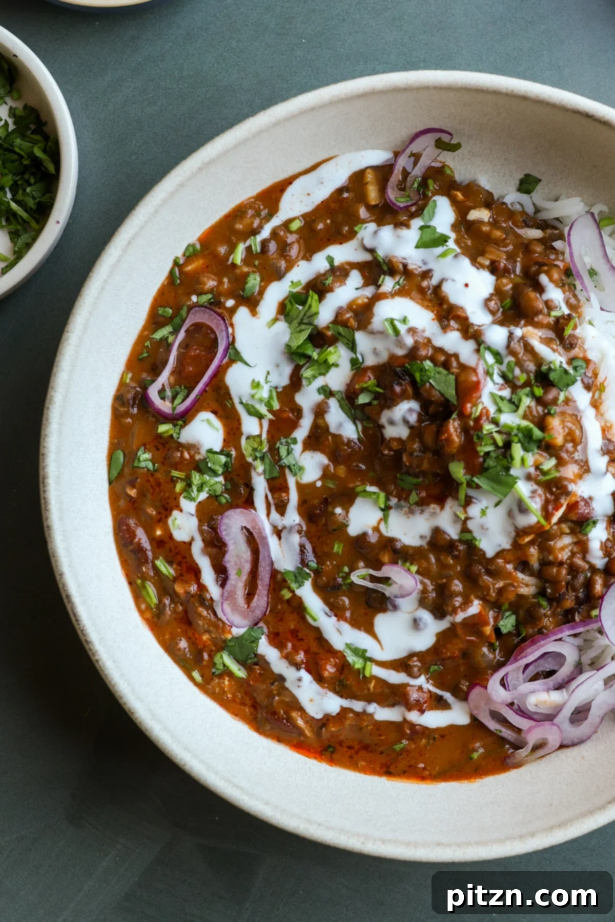 Restaurant-Quality Dal Makhani at Home 3 A close-up of Dal Makhani served in a traditional Indian bowl, showcasing its rich, creamy texture and dark color.