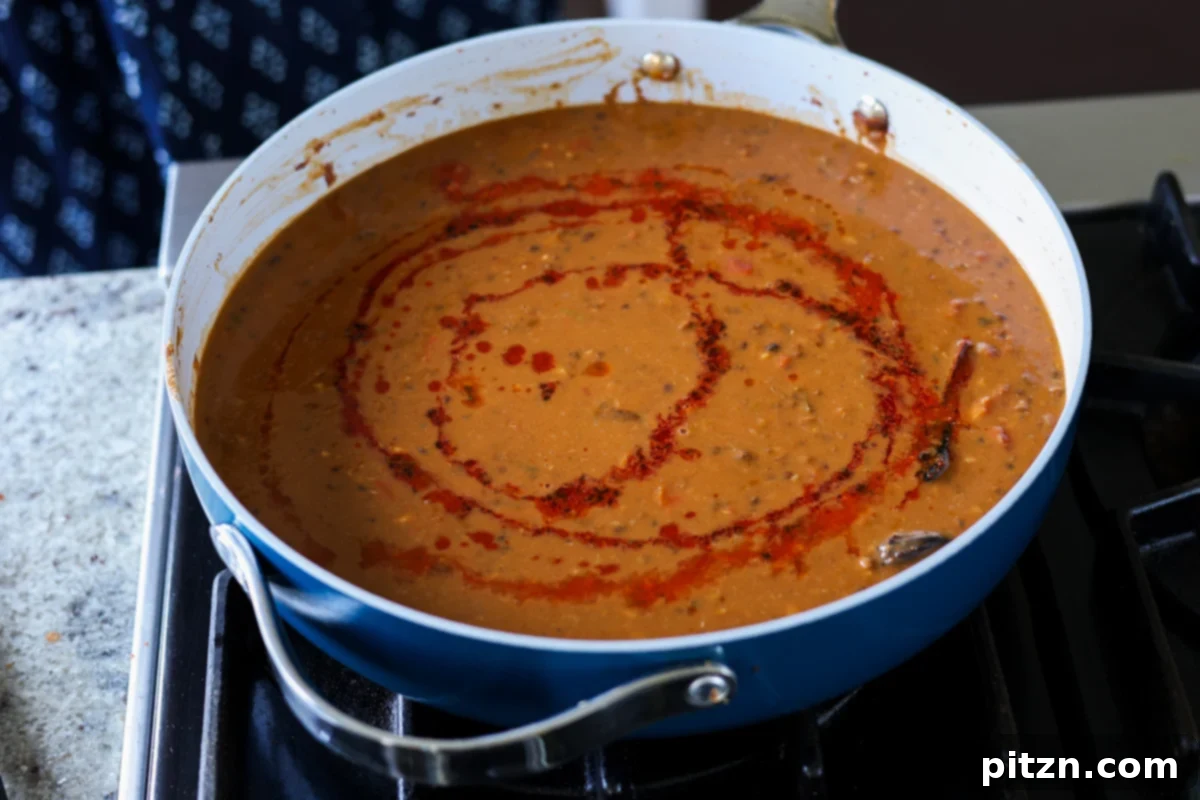 Restaurant-Quality Dal Makhani at Home 19 Dal Makhani in the main pan after the vibrant spiced oil (tadka) has been drizzled over it, ready for garnish.
