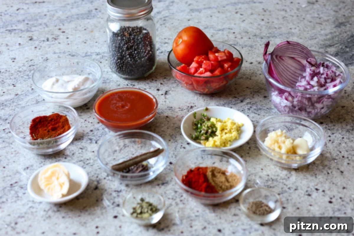 Restaurant-Quality Dal Makhani at Home 5 A vibrant display of fresh ingredients for Dal Makhani laid out on a kitchen counter, including black gram, kidney beans, spices, tomatoes, and aromatics.