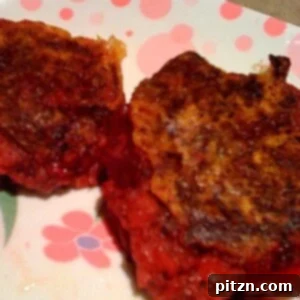 Two beet and potato cutlets on a pink and white patterned plate