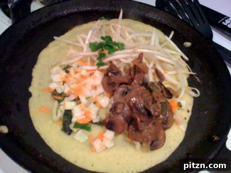 A golden crispy Banh Xeo crepe filled with savory mushrooms and fresh vegetables, ready to be enjoyed.