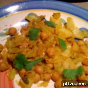 Patta Gobi Chole served on a blue patterned plate, garnished with fresh cilantro